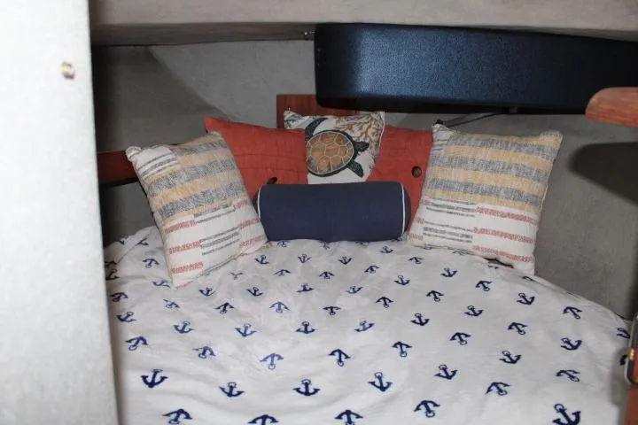 Slide: The Image of Cozy cabin interior of 1992 Bayliner 3288 Motoryacht with nautical-themed bedding and pillows. - 41