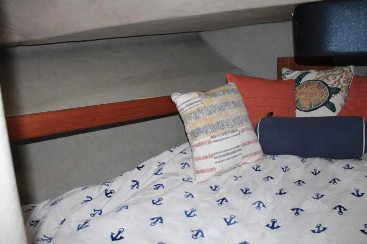 Slide: The Image of Cozy cabin interior of 1992 Bayliner 3288 Motoryacht with nautical-themed bedding and pillows. - 42