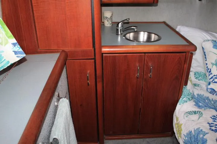 Slide: The Image of Interior of 1992 Bayliner 3288 Motoryacht with wooden cabinetry and compact sink area. - 48