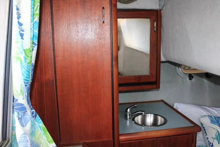 Slide: The Image of Interior of 1992 Bayliner 3288 Motoryacht with wooden cabinetry, sink, and mirror. - 49