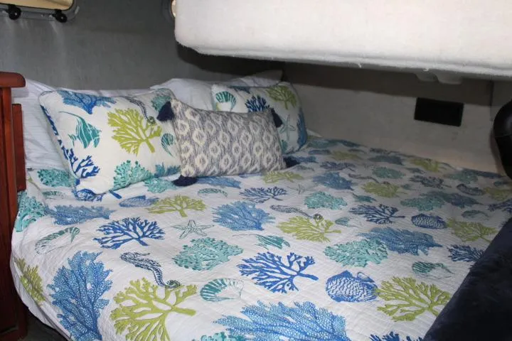 Slide: The Image of Cozy bedroom in 1992 Bayliner 3288 Motoryacht with ocean-themed bedding. - 50