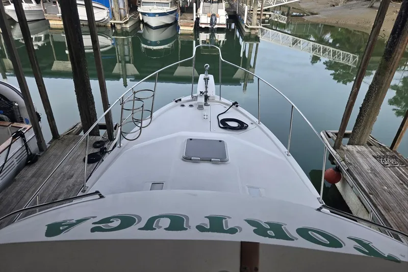 Slide: The Image of 1992 Bayliner 3288 Motoryacht docked at marina, view from bow. - 9