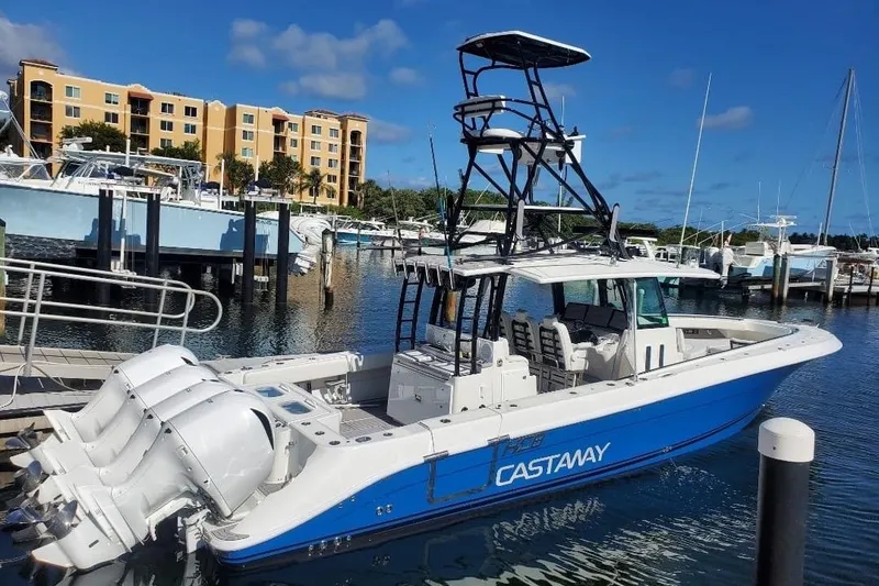 The Image of 2019 HCB 42 Siesta boat docked at marina with multiple engines and tower. - 0