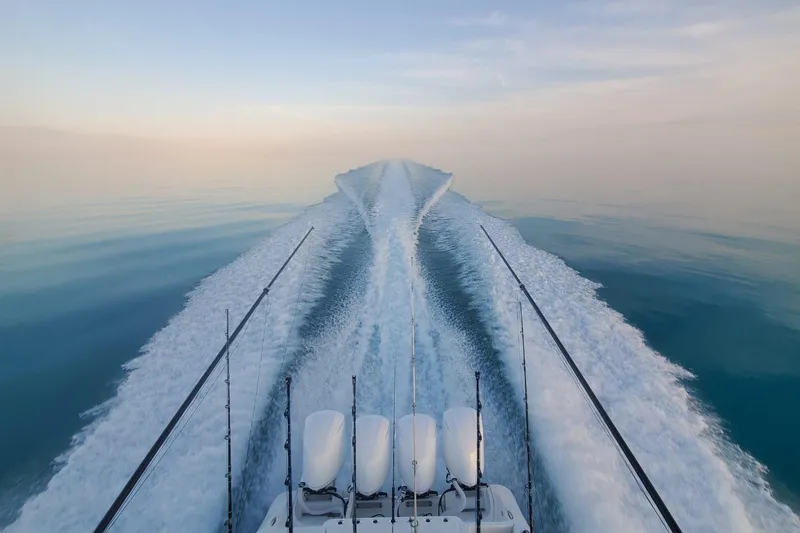 Slide: The Image of 2019 HCB 42 Siesta boat cruising on calm water, leaving a wake trail. - 12