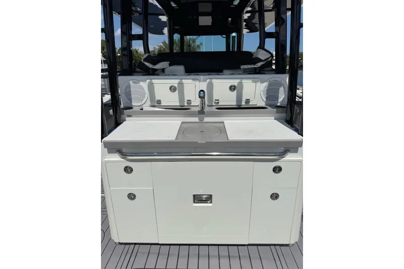 Slide: The Image of 2019 HCB 42 Siesta boat interior with sleek kitchen setup and storage cabinets. - 19
