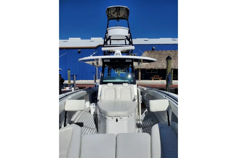 Slide: The Image of 2019 HCB 42 Siesta boat with tower, docked under clear blue sky. - 2