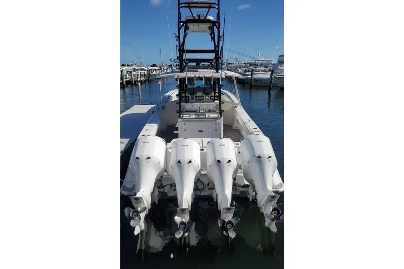 Slide: The Image of 2019 HCB 42 Siesta boat with four powerful outboard engines docked at marina. - 3