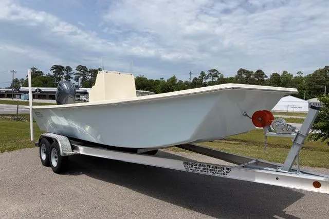 The Image of 2026 Jones Brothers Bateau 23 boat on trailer, parked outdoors under cloudy sky. - 0