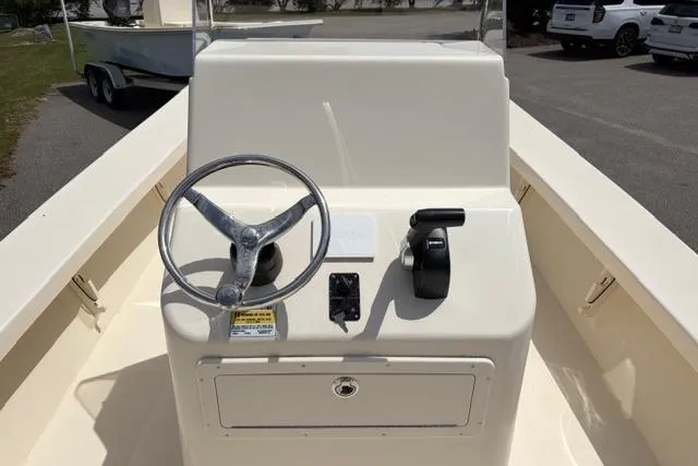 Slide: The Image of 2026 Jones Brothers Bateau 23 boat console with steering wheel and controls. - 2