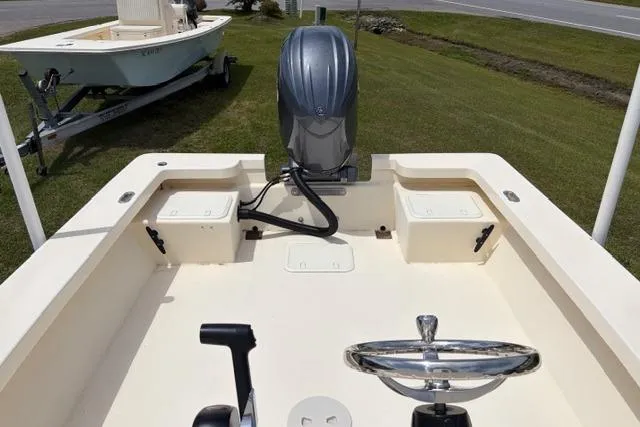 Slide: The Image of 2026 Jones Brothers Bateau 23 boat interior with steering wheel and outboard motor. - 3