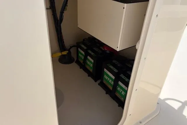 Slide: The Image of Battery compartment of 2026 Jones Brothers Bateau 23 boat, featuring multiple Interstate batteries. - 8