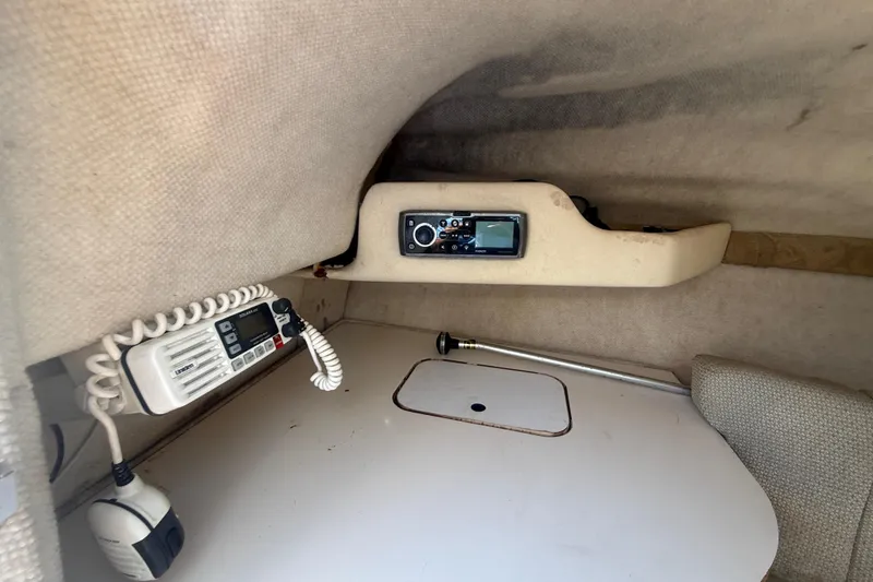 Slide: The Image of 2004 Sea Ray 215 Weekender cabin interior with radio and communication equipment. - 14