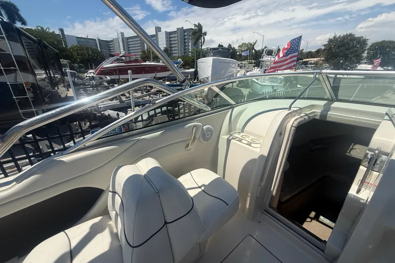 Slide: The Image of 2004 Sea Ray 215 Weekender boat interior with seating and cabin entrance. - 7