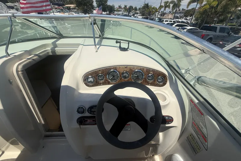 Slide: The Image of 2004 Sea Ray 215 Weekender boat dashboard with steering wheel and gauges. - 8