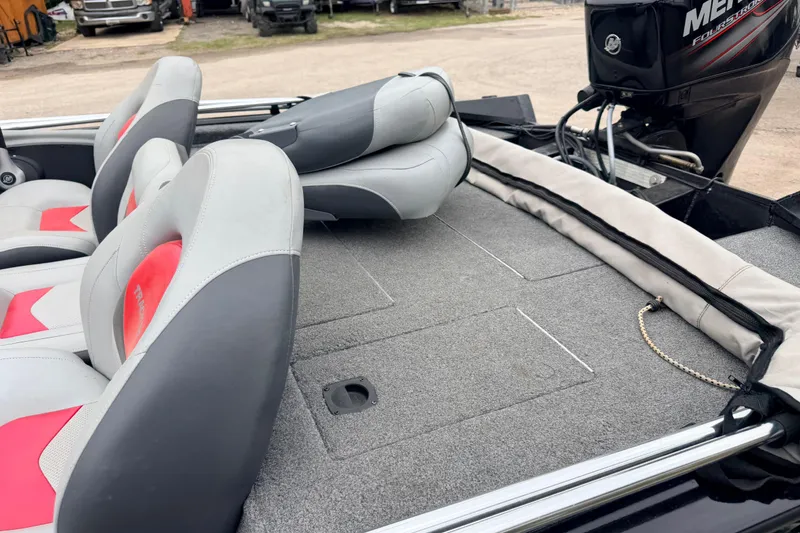 Slide: The Image of 2014 Tracker Pro Team 175 TXW boat interior with seating and Mercury engine. - 7