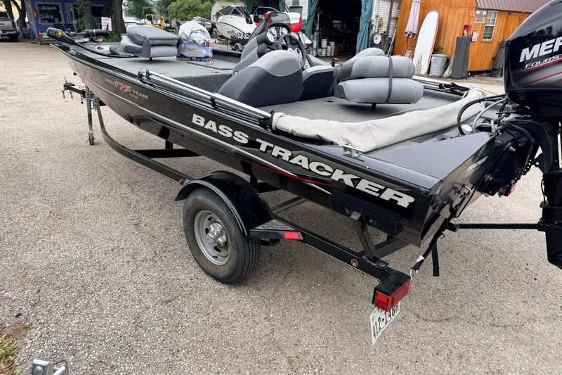 Slide: The Image of 2014 Tracker Pro Team 175 TXW bass boat on trailer, parked outdoors. - 8