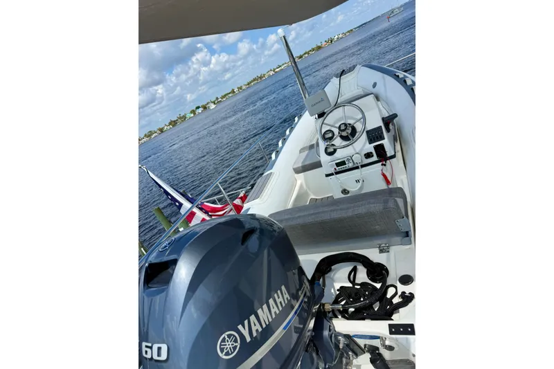Slide: The Image of 2016 Caribe 16 boat with Yamaha engine on a sunny day by the water. - 4