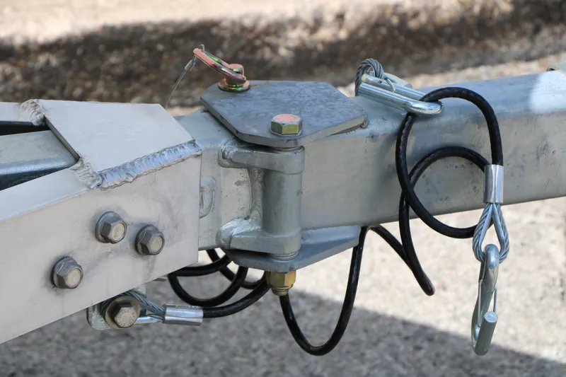 Slide: The Image of Trailer hitch assembly of 2026 Vexus Defender 201 with safety cables and bolts. - 12