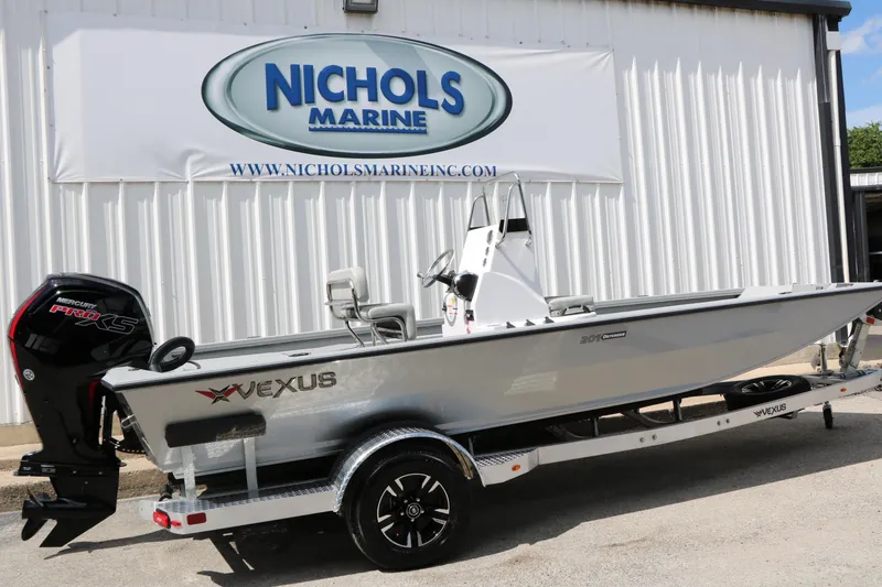 Slide: The Image of 2026 Vexus Defender 201 boat on trailer at Nichols Marine dealership. - 8