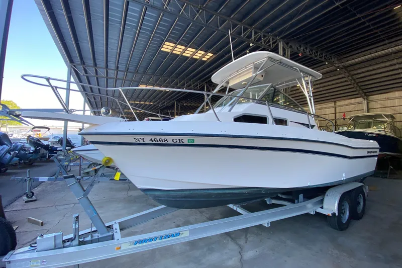 The Image of 1997 Grady-White Gulfstream 232 boat on trailer in covered storage. - 0