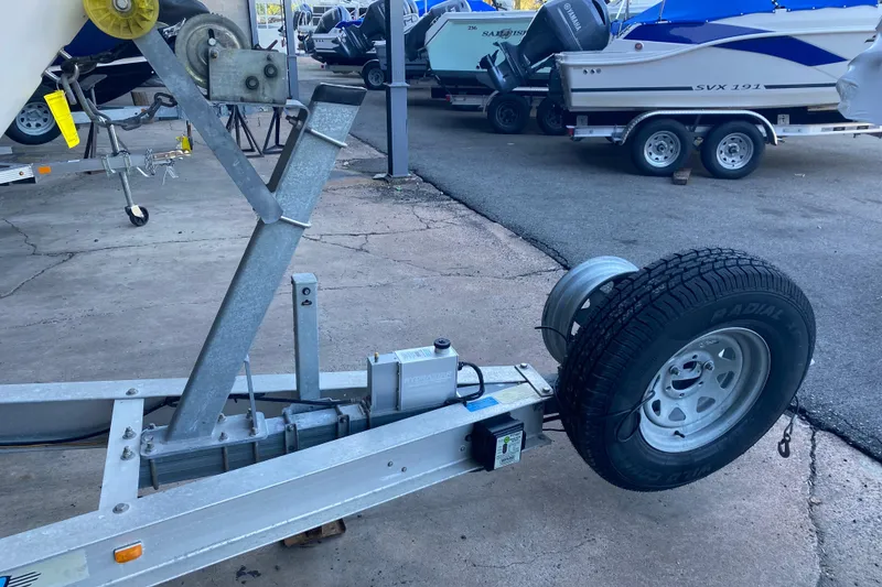 Slide: The Image of Trailer for 1997 Grady-White Gulfstream 232 boat in a marina setting. - 13