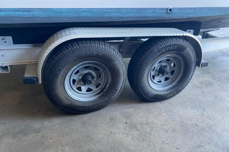 Slide: The Image of Trailer wheels of a 1997 Grady-White Gulfstream 232 boat on a concrete floor. - 14