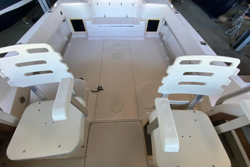 Slide: The Image of 1997 Grady-White Gulfstream 232 boat interior with white seating and spacious deck. - 5
