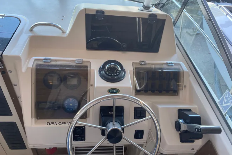 Slide: The Image of 1997 Grady-White Gulfstream 232 boat dashboard with steering wheel and instrument panel. - 6