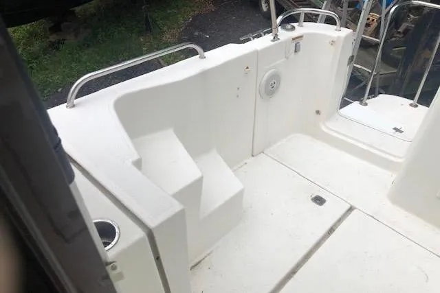 Slide: The Image of 2013 Ranger Tugs R-29 S boat deck with white seating and railing. - 11