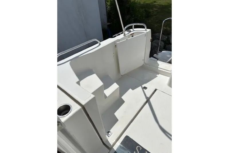 Slide: The Image of 2013 Ranger Tugs R-29 S boat deck with steps and railing in sunlight. - 12