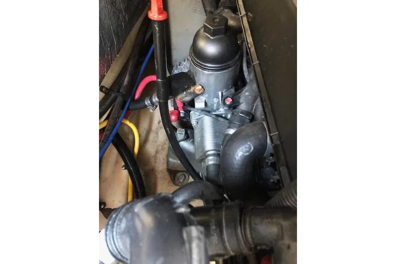 Slide: The Image of Engine compartment of 2013 Ranger Tugs R-29 S with visible hoses and wiring. - 17