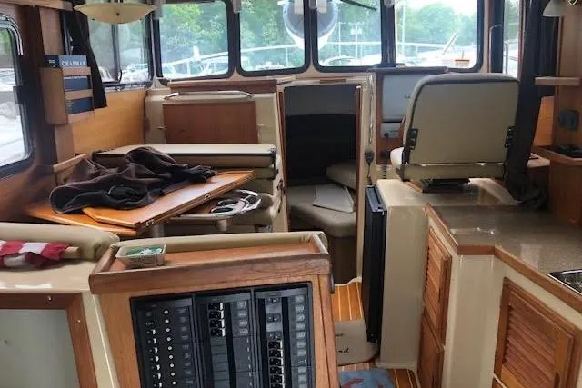 Slide: The Image of Interior of 2013 Ranger Tugs R-29 S boat, featuring helm, seating, and control panels. - 18