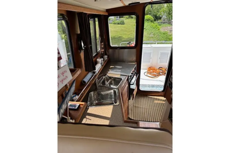 Slide: The Image of Interior of 2013 Ranger Tugs R-29 S boat with kitchen and outdoor view. - 19