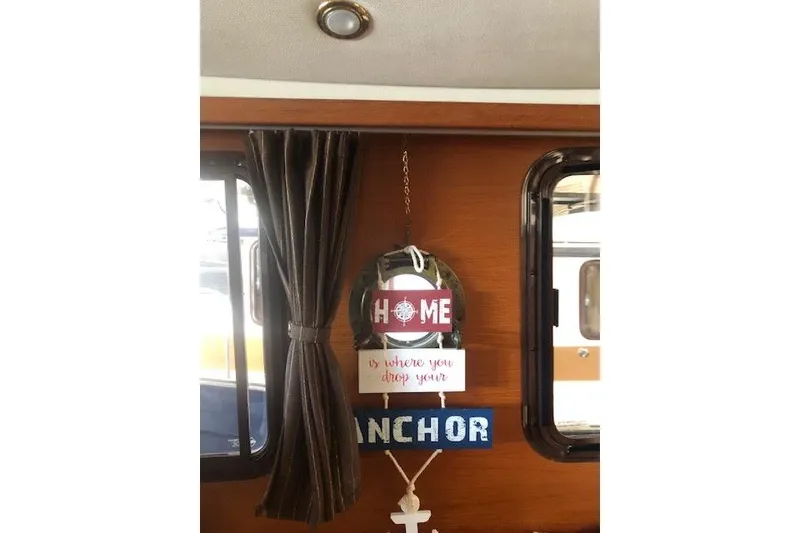 Slide: The Image of Interior of 2013 Ranger Tugs R-29 S with nautical decor and inspirational sign. - 22