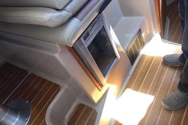 Slide: The Image of Interior of 2013 Ranger Tugs R-29 S with wood flooring and compact refrigerator. - 29