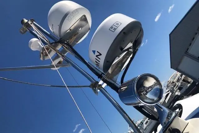 Slide: The Image of Radar and communication equipment on a 2013 Ranger Tugs R-29 S boat under a clear blue sky. - 3