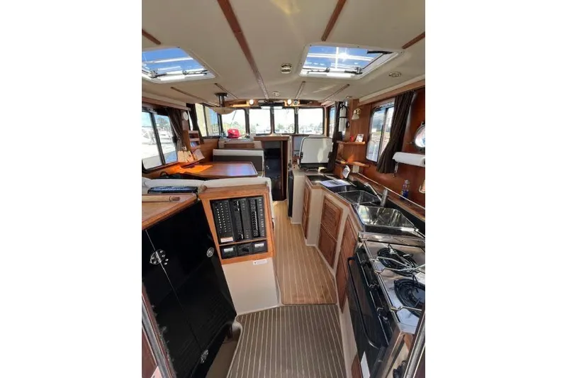 Slide: The Image of Interior of 2013 Ranger Tugs R-29 S boat, featuring kitchen and seating area. - 37