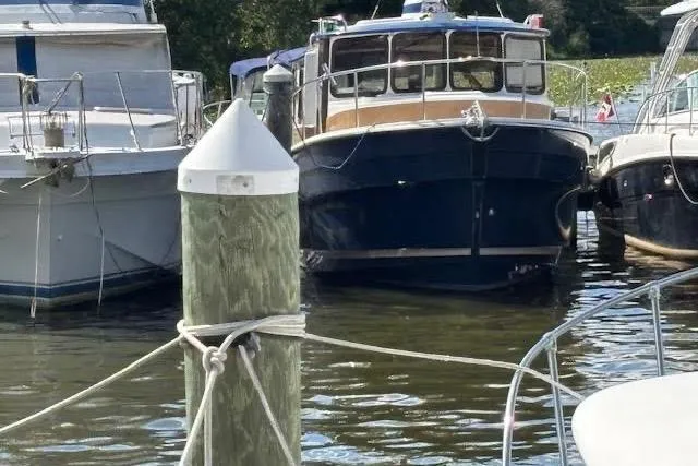 Slide: The Image of 2013 Ranger Tugs R-29 S docked between boats at a marina. - 4