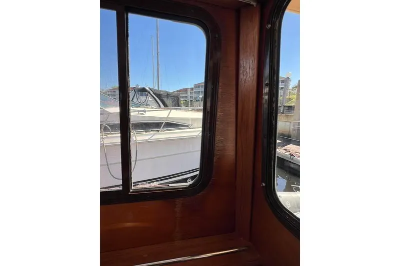 Slide: The Image of Interior view from a 2013 Ranger Tugs R-29 S, showcasing marina through windows. - 44