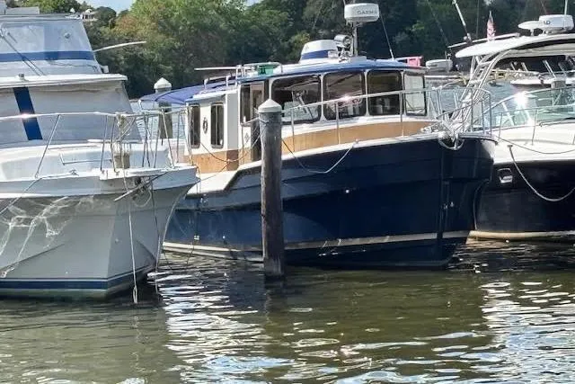 Slide: The Image of 2013 Ranger Tugs R-29 S docked among other boats in a marina. - 5
