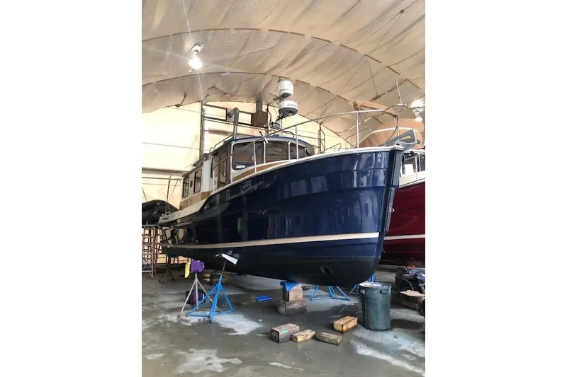 Slide: The Image of 2013 Ranger Tugs R-29 S boat in indoor storage, elevated on stands. - 9