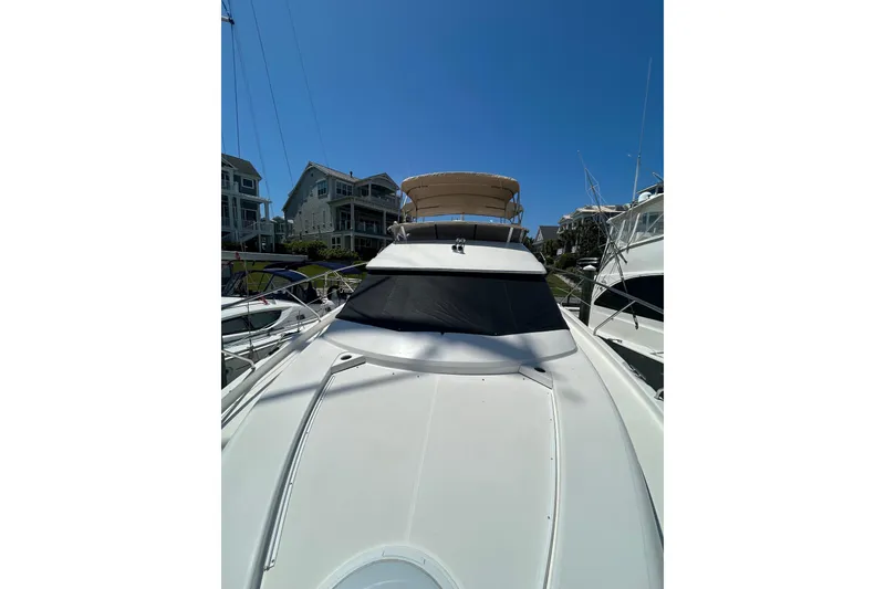 Slide: The Image of 2001 Silverton 410 Sport Bridge yacht docked under clear blue sky. - 10