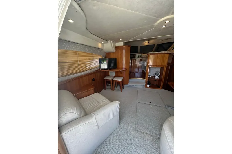 Slide: The Image of Interior of 2001 Silverton 410 Sport Bridge yacht with cozy seating and entertainment area. - 17