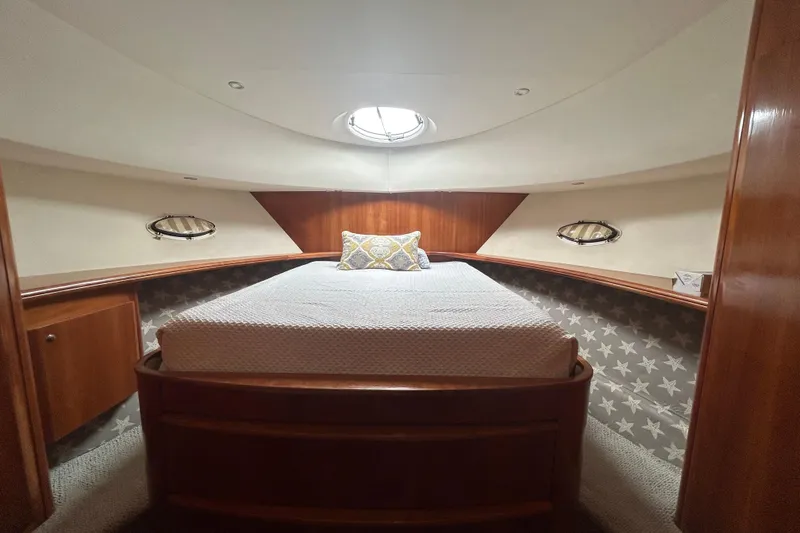 Slide: The Image of Interior cabin of 2001 Silverton 410 Sport Bridge yacht with cozy bed and porthole windows. - 22
