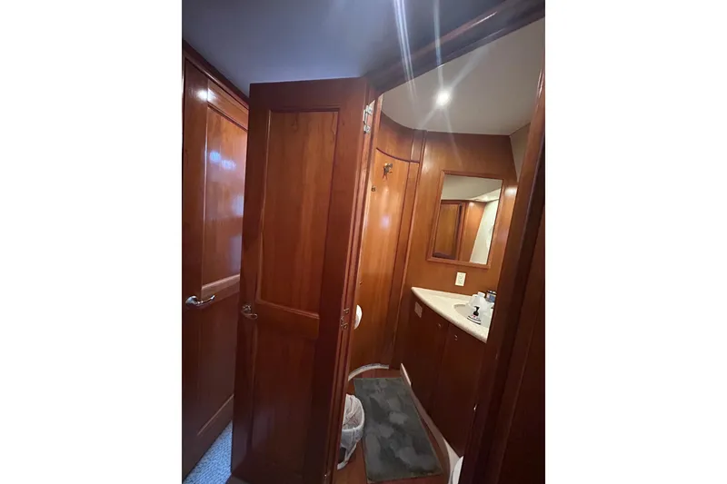 Slide: The Image of Interior of 2001 Silverton 410 Sport Bridge yacht bathroom with wooden cabinetry. - 26