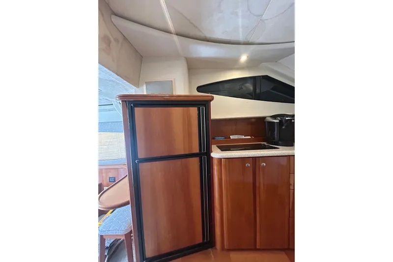 Slide: The Image of Interior of 2001 Silverton 410 Sport Bridge yacht with wooden cabinetry and modern appliances. - 28