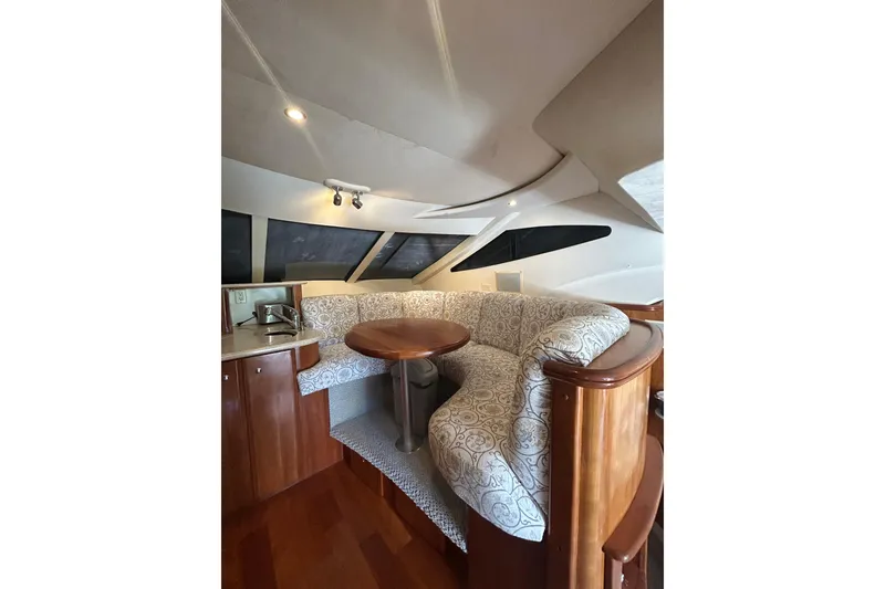 Slide: The Image of Interior of 2001 Silverton 410 Sport Bridge with elegant seating and wooden table. - 29