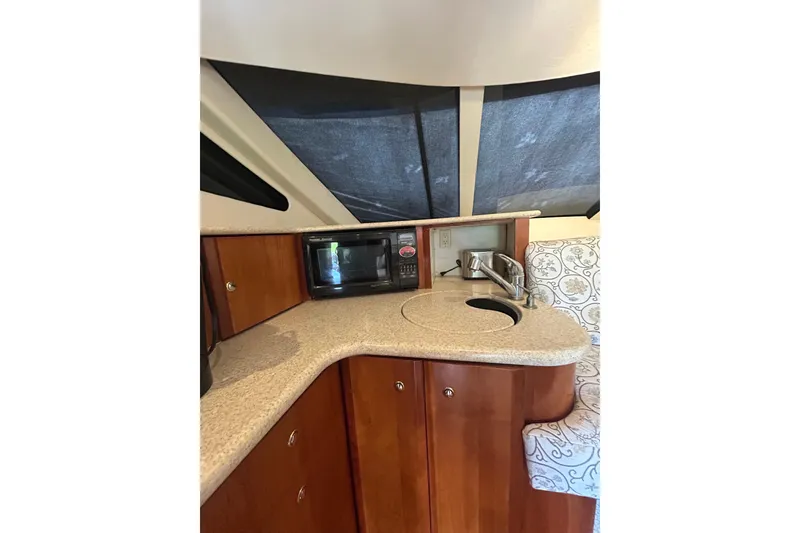 Slide: The Image of 2001 Silverton 410 Sport Bridge kitchen area with microwave and sink. - 30