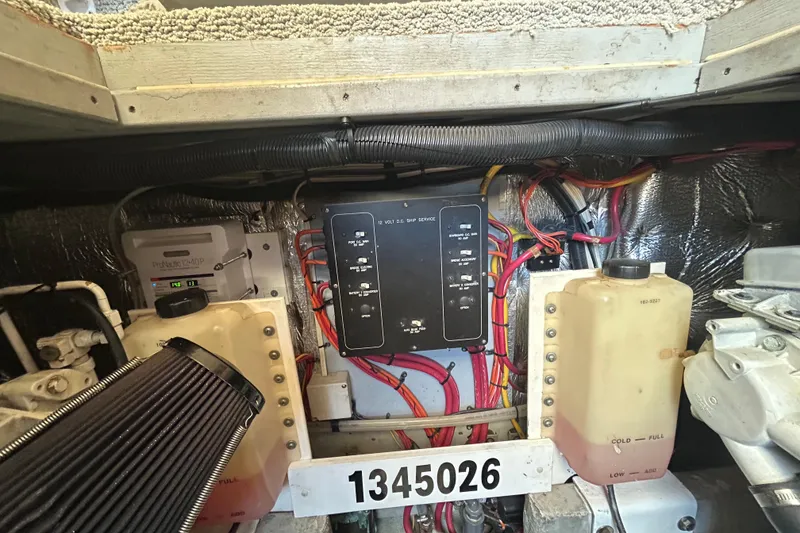Slide: The Image of Engine room of a 2001 Silverton 410 Sport Bridge with wiring and fluid tanks. - 7