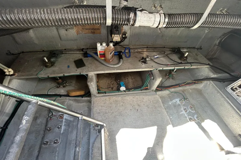 Slide: The Image of Engine compartment of a 2001 Silverton 410 Sport Bridge with visible wiring and maintenance supplies. - 8